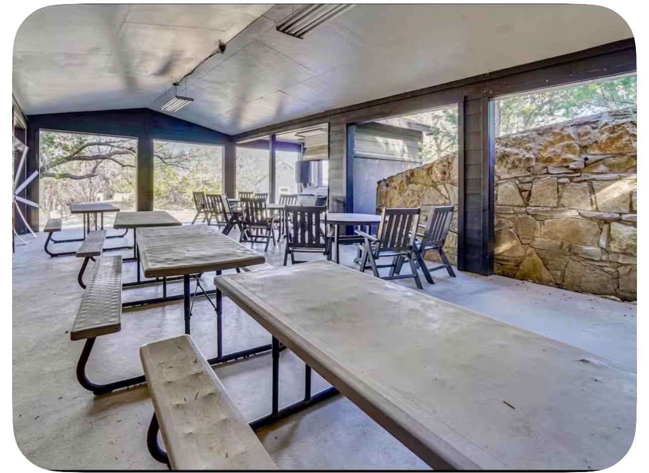 Covered pavilion with picnic tables and stone walls